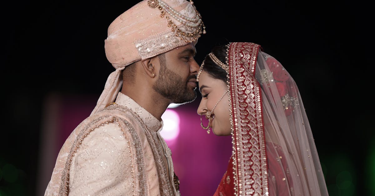 Bride and groom in traditional attire sharing a moment during their wedding.