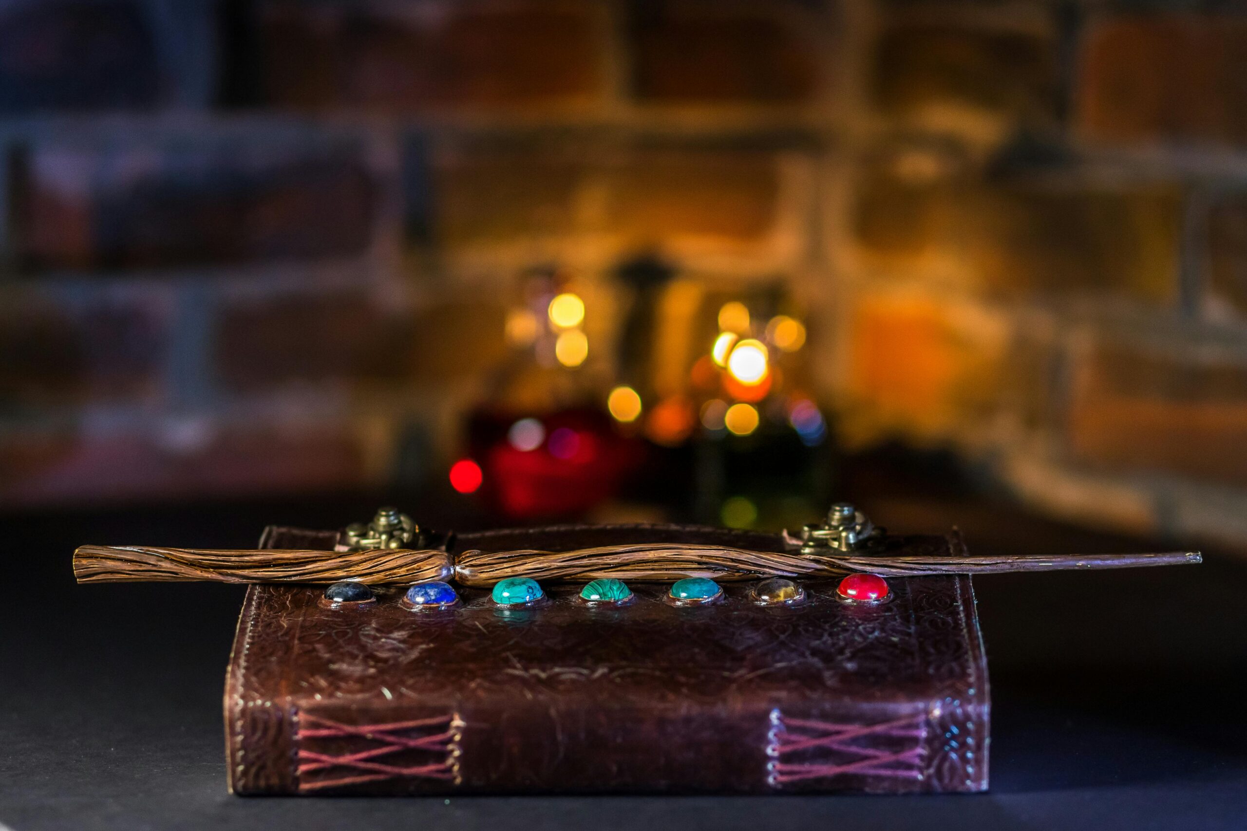 A close-up of a magical wand resting on a spell book with colorful potions in the background.